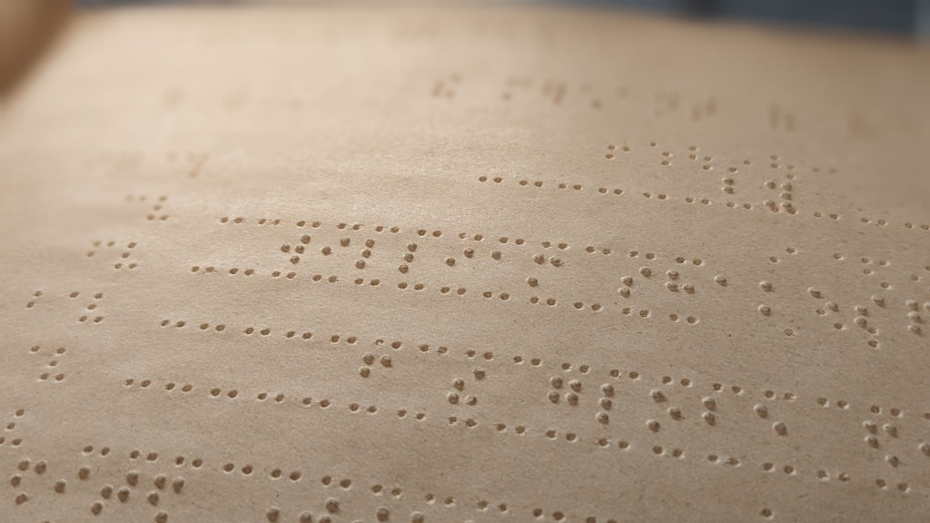 4 lines of embossed braille lettering