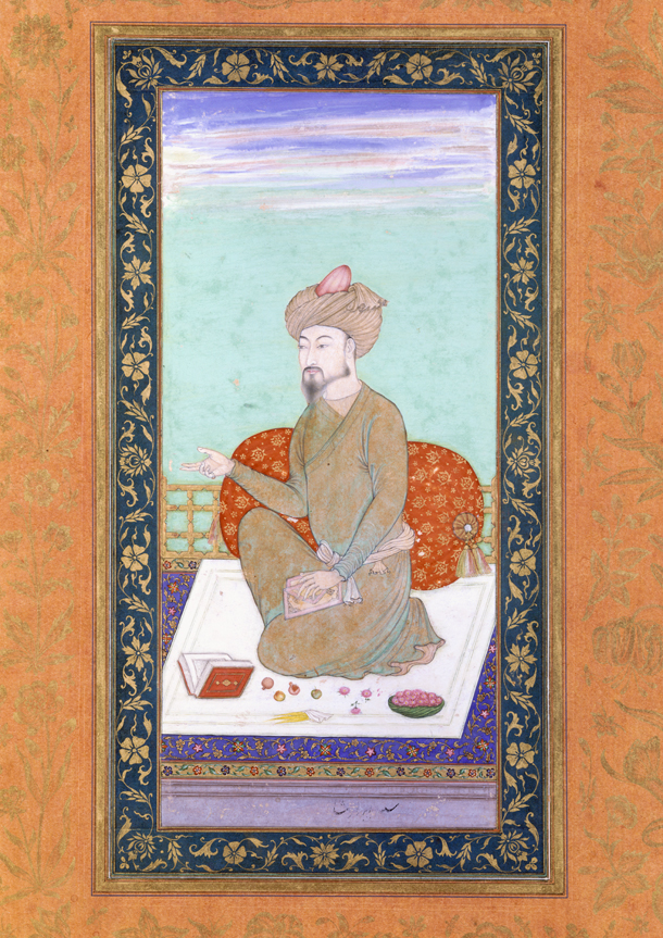 Man with beard and moustache, wearing a turban, kneeling on a rug. On the rug next to him is a book and some food. 
